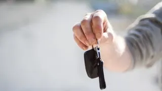 Hand holding car keys