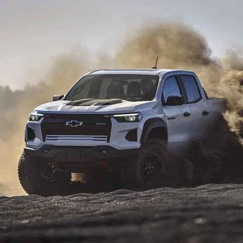 2023 Chevrolet Colorado - White truck (front view) driving off road