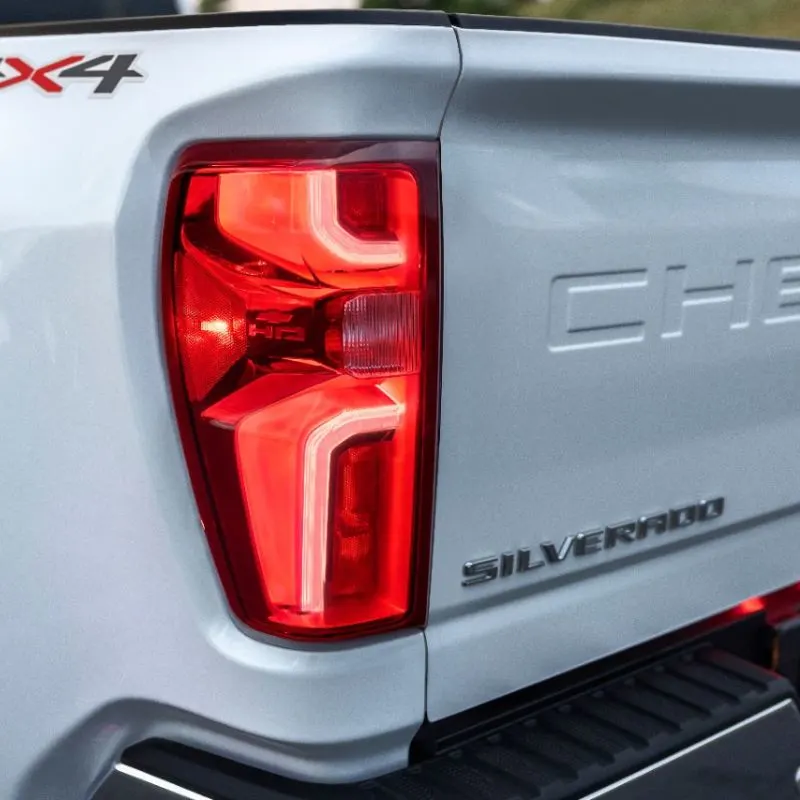 Detail shot of taillamps, Silverado emboss, Chevrolet deboss and 4x4 badge on 2024 Chevrolet Silverado 3500HD LTZ