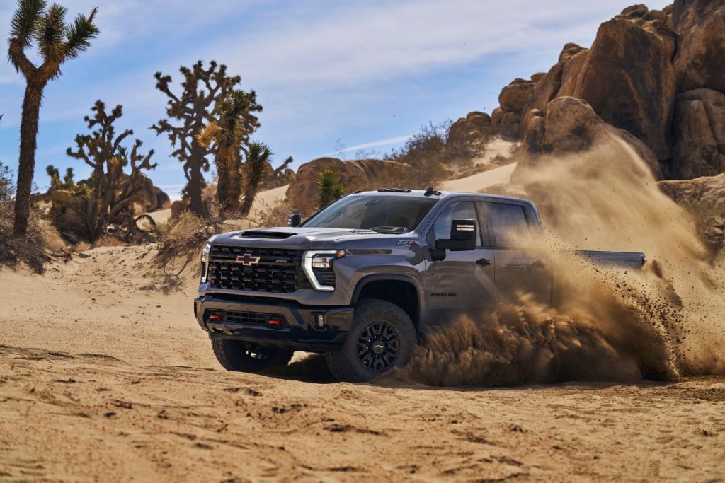 2024 Chevrolet Silverado – The Easiest To Read Review - The Silverado HD ZR2 in a desert scene, kicking up dust.