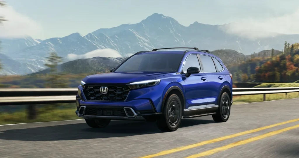 The 2024 Honda CR-V - Blue driving on a highway