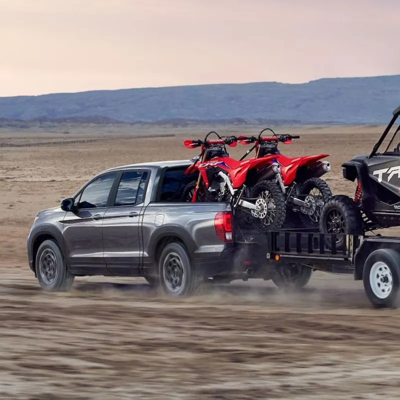 2024 Honda Ridgeline - Gray truck (lateral view) towing an ATV