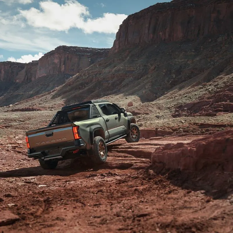 2024 Toyota Tacoma - Green truck (Rear view) driving off road