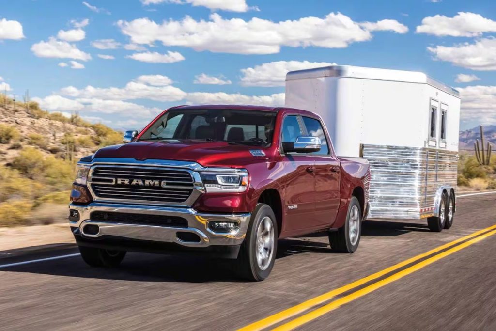 2024 Dodge Ram - Red truck (3/4 view) towing a trailer