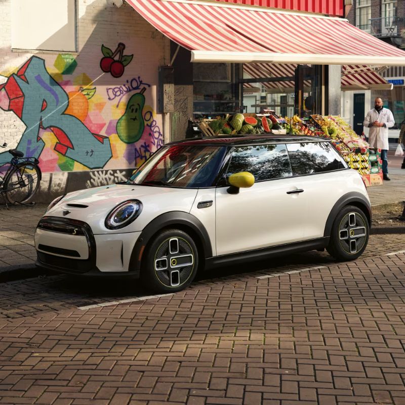 2024 MIni Electric Hardtop Parked In Front Of A Corner Store