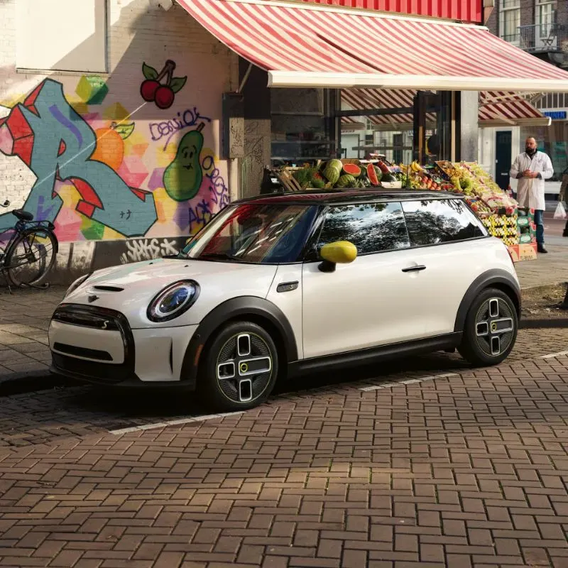 2024 MIni Electric Hardtop Parked In Front Of A Corner Store
